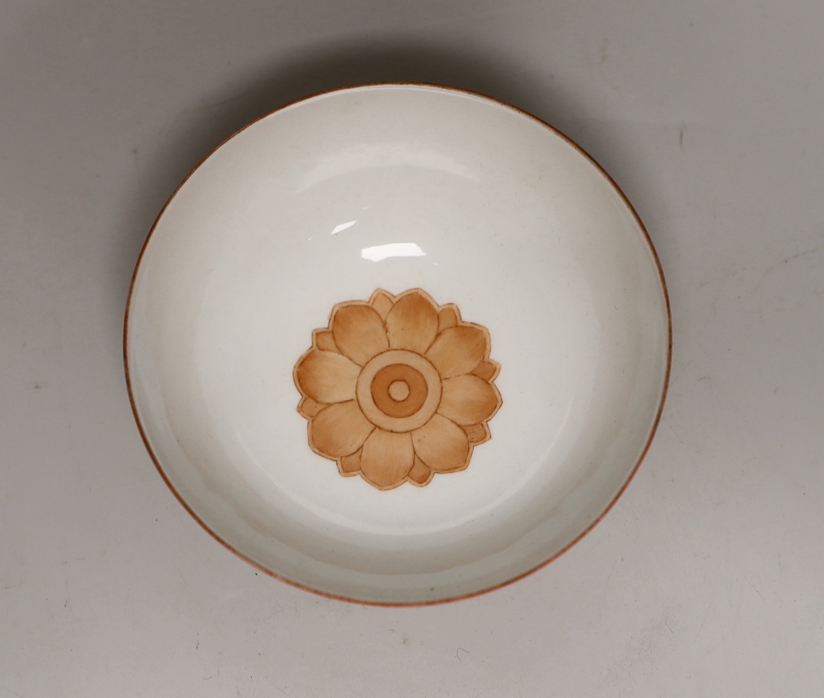 A Chinese coral red ground bowl, gilded with figures, 14cm diameter